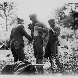 German POW being searched by American troops