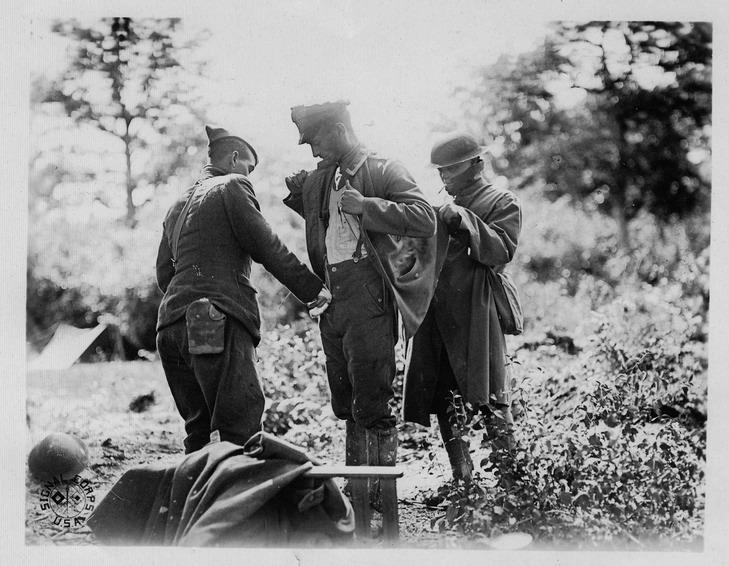 German POW being searched by American troops
